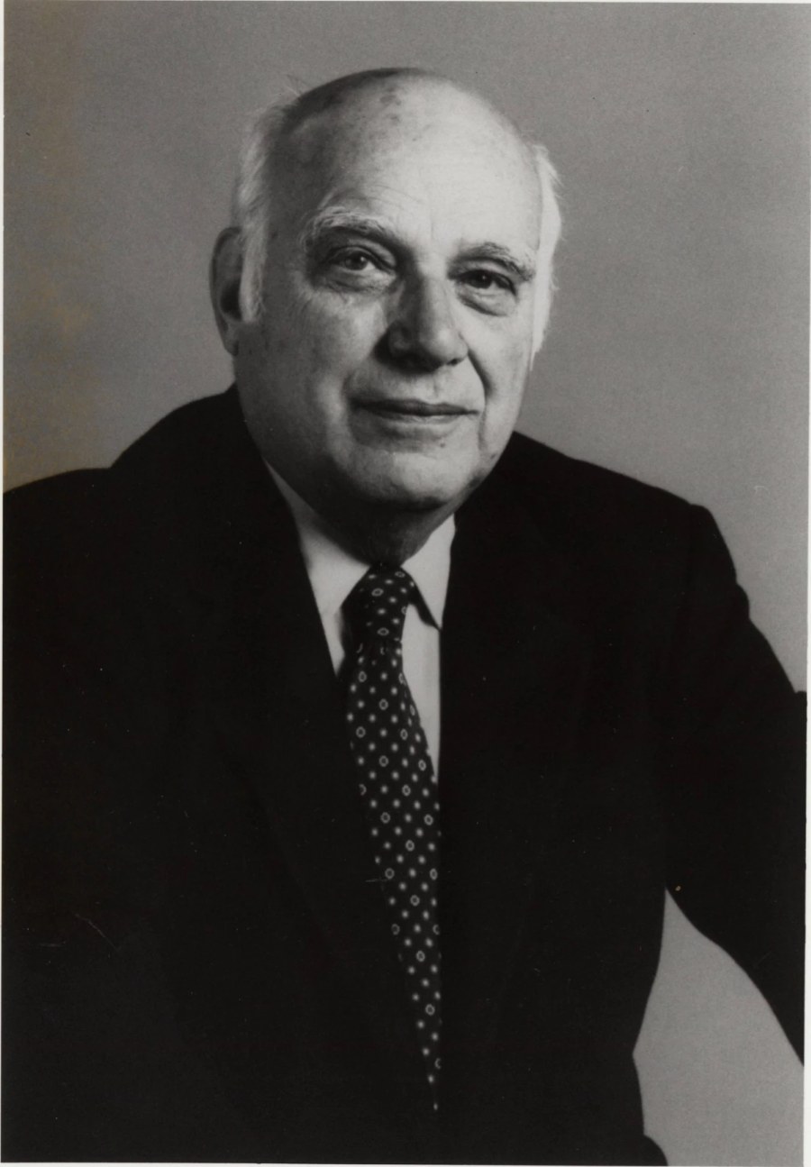 Portrait of Edward E Rosenbaum in a dark suit and tie