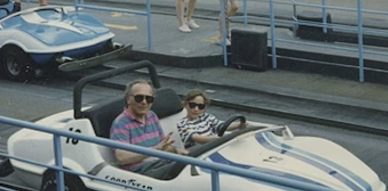 Jen Rosenbaum as a child, at the wheel of a car on an amusement park track